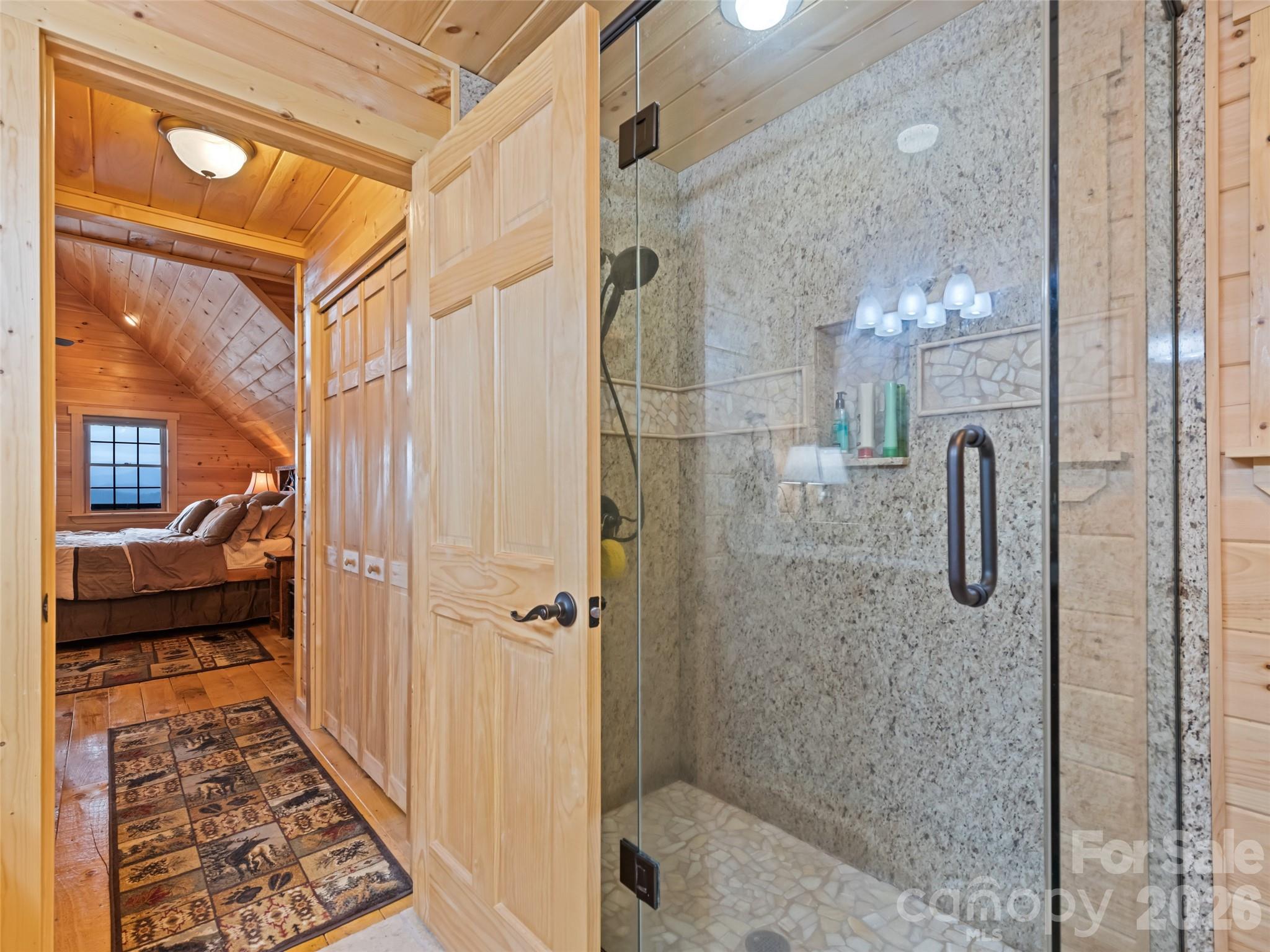 693 High Splendor Drive Robbinsville, NC 28771 - Photo 29 of 48 a bathroom with a glass shower door