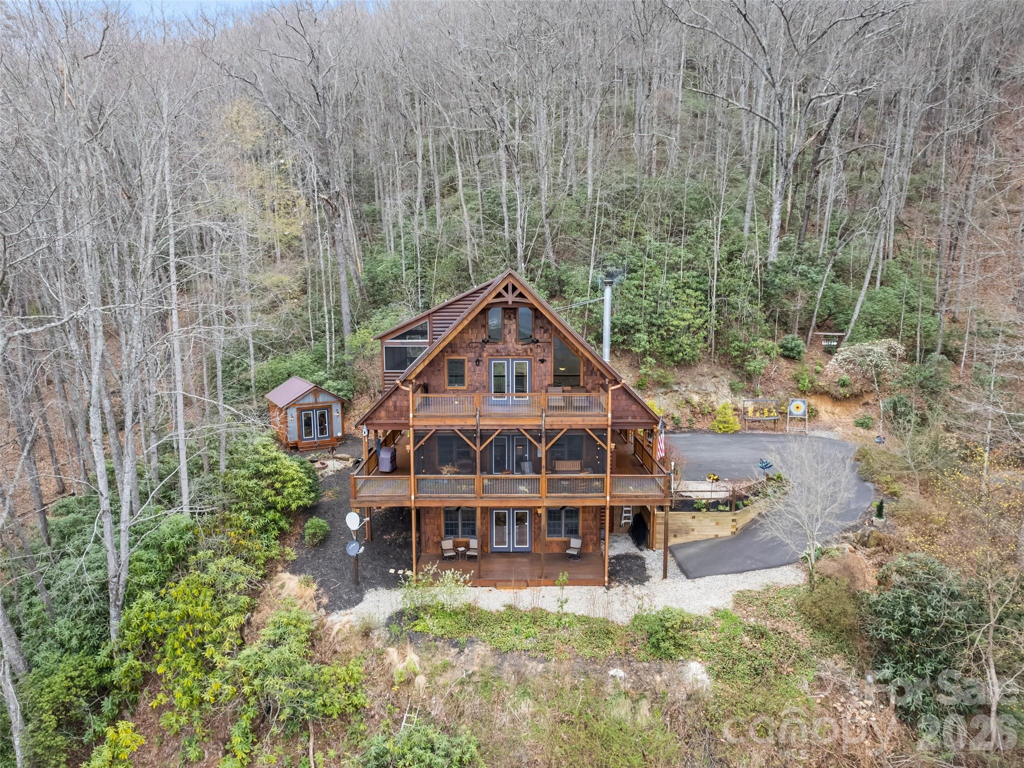 693 High Splendor Drive Robbinsville, NC 28771 - Photo 3 of 48 a big house with tall trees in the background