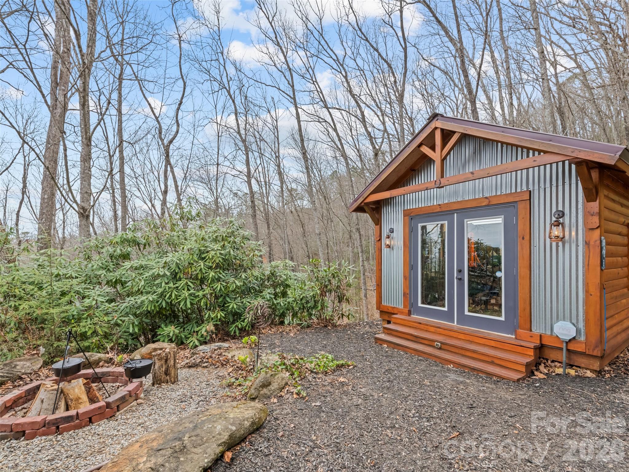 693 High Splendor Drive Robbinsville, NC 28771 - Photo 48 of 48 a backyard of a house with large trees and barbeque oven