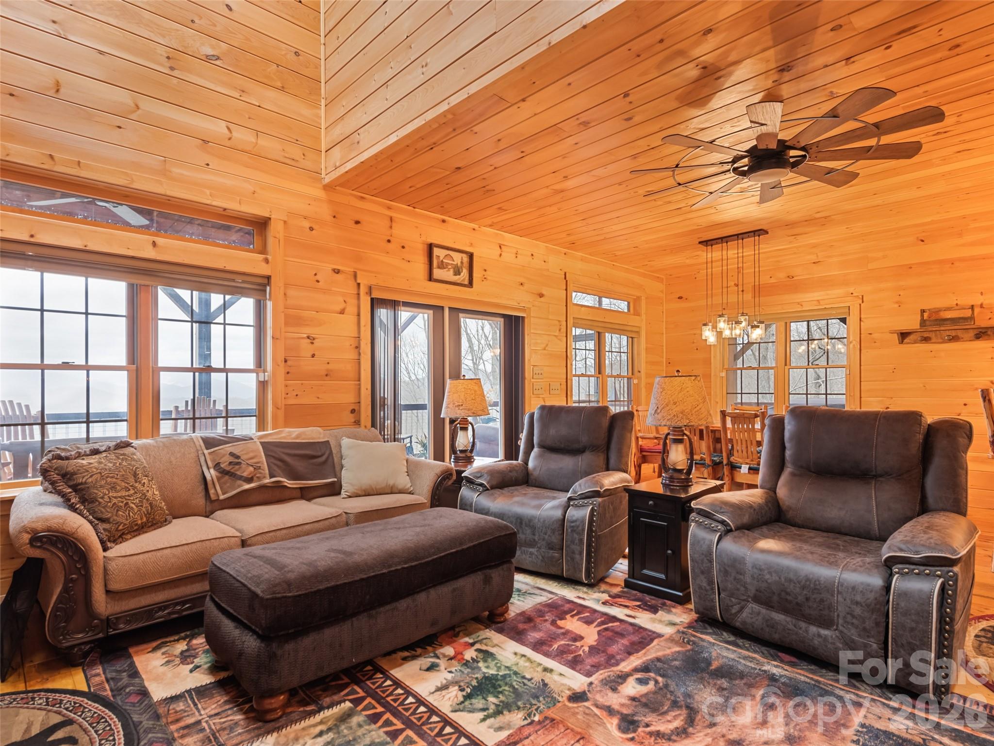693 High Splendor Drive Robbinsville, NC 28771 - Photo 7 of 48 a living room with furniture a rug and a chandelier