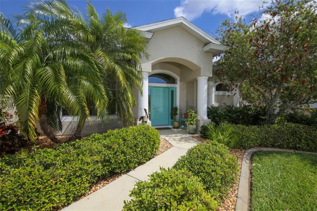 149 Bunker Road Rotonda West, FL 33947 - Photo 1 of 1 Welcoming entry with lush landscaping