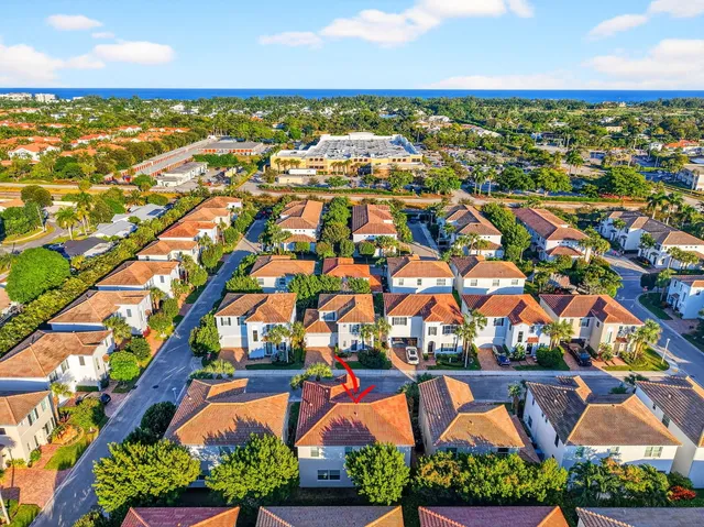an aerial view of residential houses with outdoor space and swimming pool