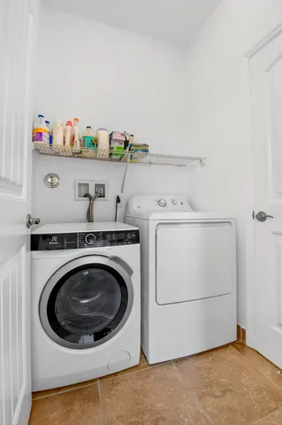 a bedroom with bed and paintings on wall