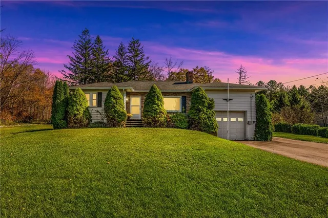 a front view of a house with a garden