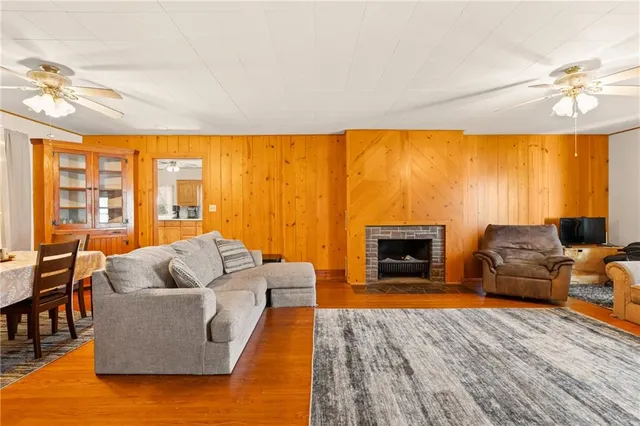 a living room with furniture wooden floor and a large window