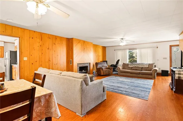 a living room with furniture fireplace and a large window