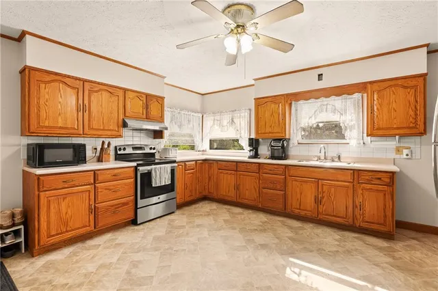 a large kitchen with cabinets and stainless steel appliances