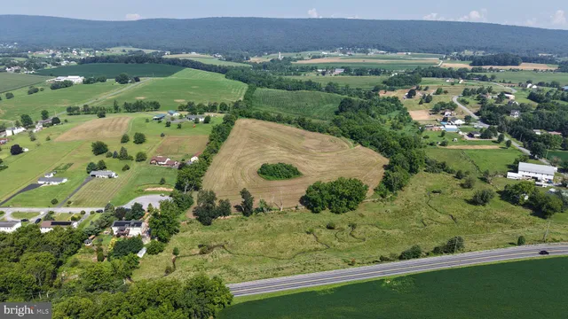 an aerial view of a residential houses with outdoor space and lake view