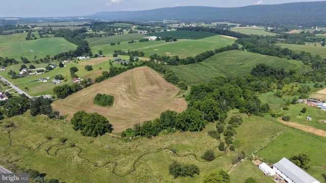 an aerial view of a house with a yard and lake view