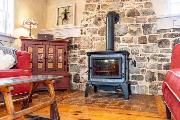 a living room with furniture a large window and a fireplace
