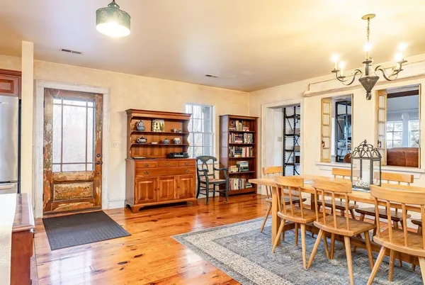 a kitchen with stainless steel appliances granite countertop a sink a stove cabinets counter space and a window