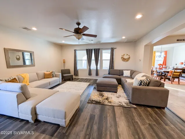 a dining room with furniture and a floor to ceiling window