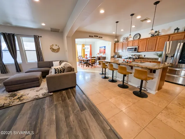 a kitchen with stainless steel appliances granite countertop a sink a stove counter space and cabinets