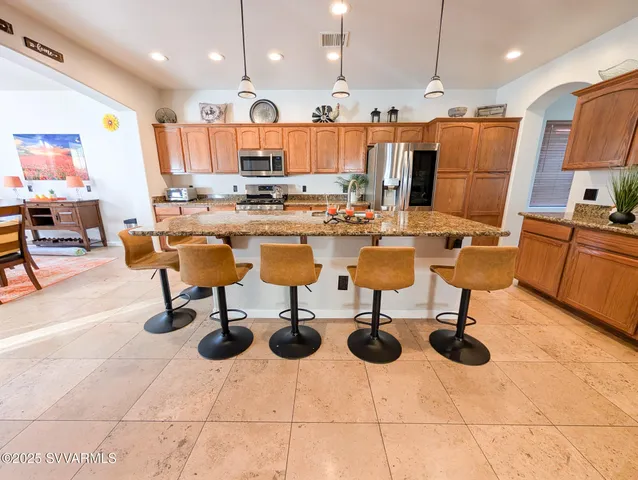 a large bathroom with a granite countertop double vanity sink a mirror and a shower