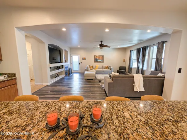 a view of a livingroom with wooden floor and staircase