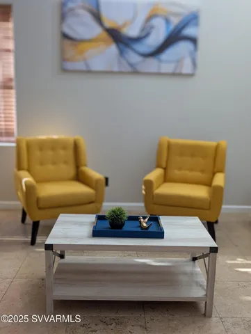 a bedroom with two bed and a chair