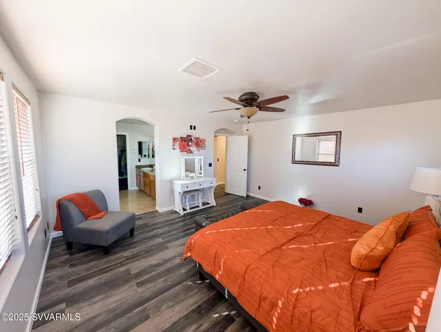 a large kitchen with kitchen island a large counter top stainless steel appliances and cabinets