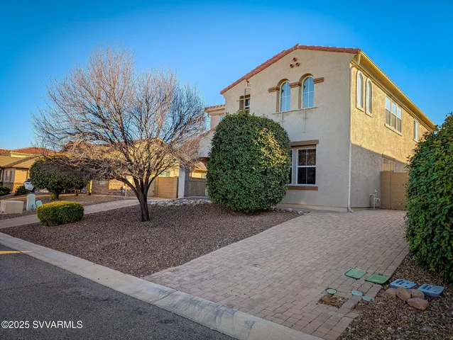 a bedroom with a bed flat screen tv and a large window