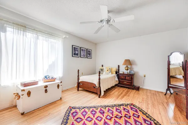 a bedroom with furniture and a wooden floor