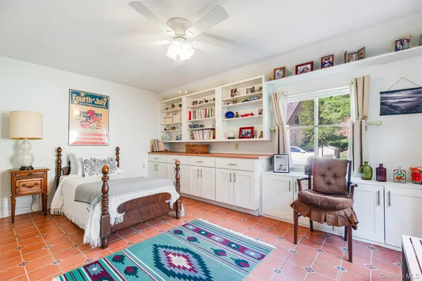 a bedroom with furniture and a window