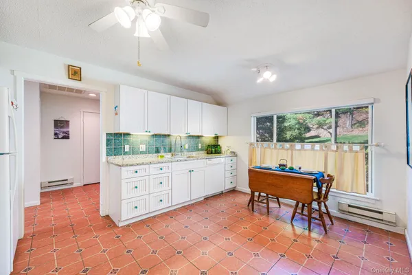 a white refrigerator freezer sitting inside of a kitchen