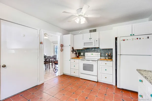 a kitchen with stainless steel appliances kitchen island granite countertop a refrigerator sink and cabinets