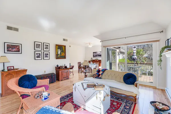 a living room with furniture and hard wood floor
