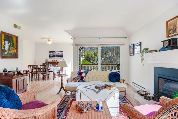 a living room with furniture and a floor to ceiling window