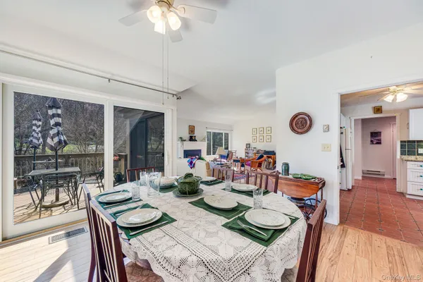 a dining room with furniture a chandelier and wooden floor