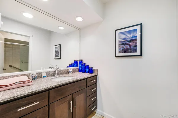a bathroom with a sink vanity and a mirror