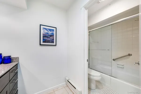 a white toilet sitting next to a bathroom sink and vanity
