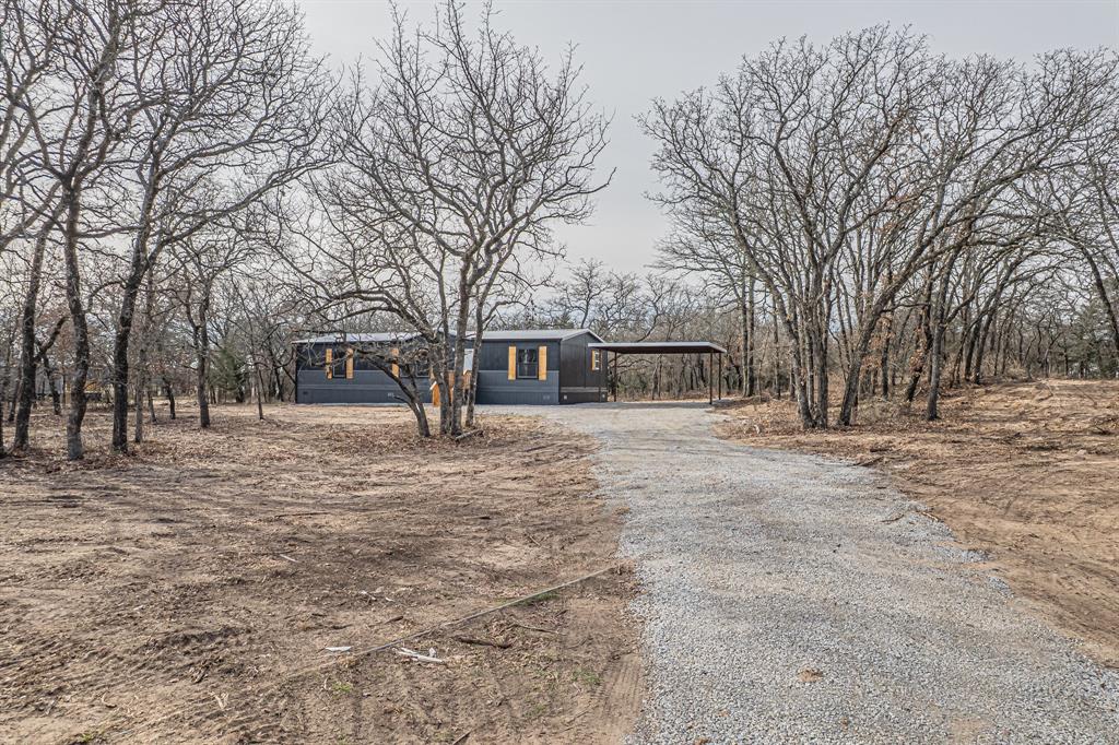 300 Huddleston Road Sunset, TX 76270 - Photo 38 of 40 a front view of a house with large trees