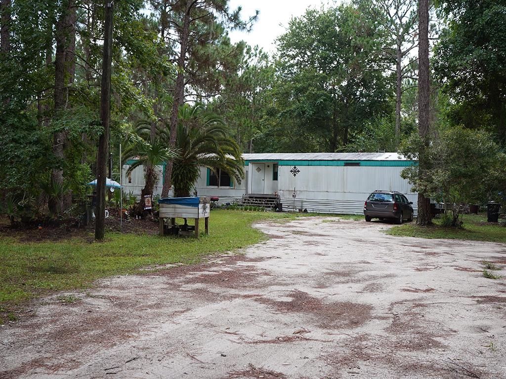 2100 Deer Run Road St. Augustine, FL 32084 - Photo 12 of 17 a view of a house with backyard and a tree