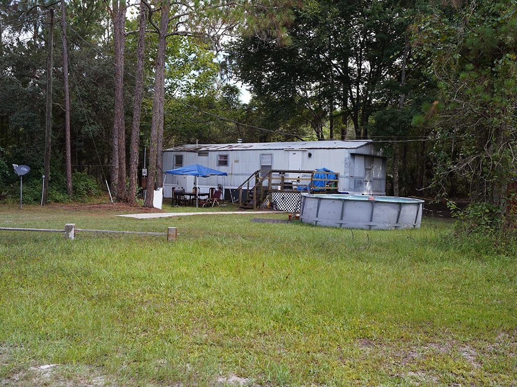 2100 Deer Run Road St. Augustine, FL 32084 - Photo 14 of 17 a view of a backyard with swimming pool and sitting area