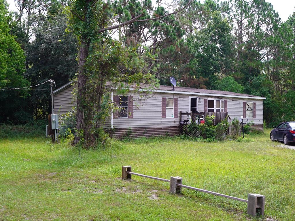 2100 Deer Run Road St. Augustine, FL 32084 - Photo 15 of 17 a backyard of a house with barbeque oven table and chairs
