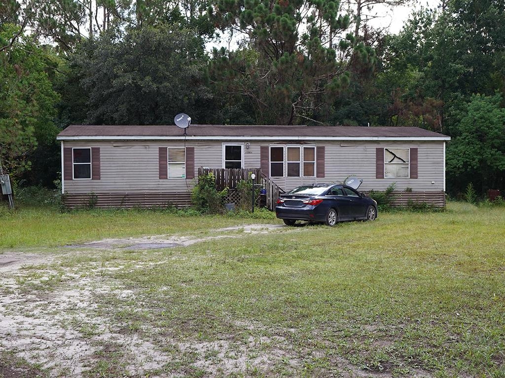 2100 Deer Run Road St. Augustine, FL 32084 - Photo 16 of 17 a house that has a lot of plants and trees in the background