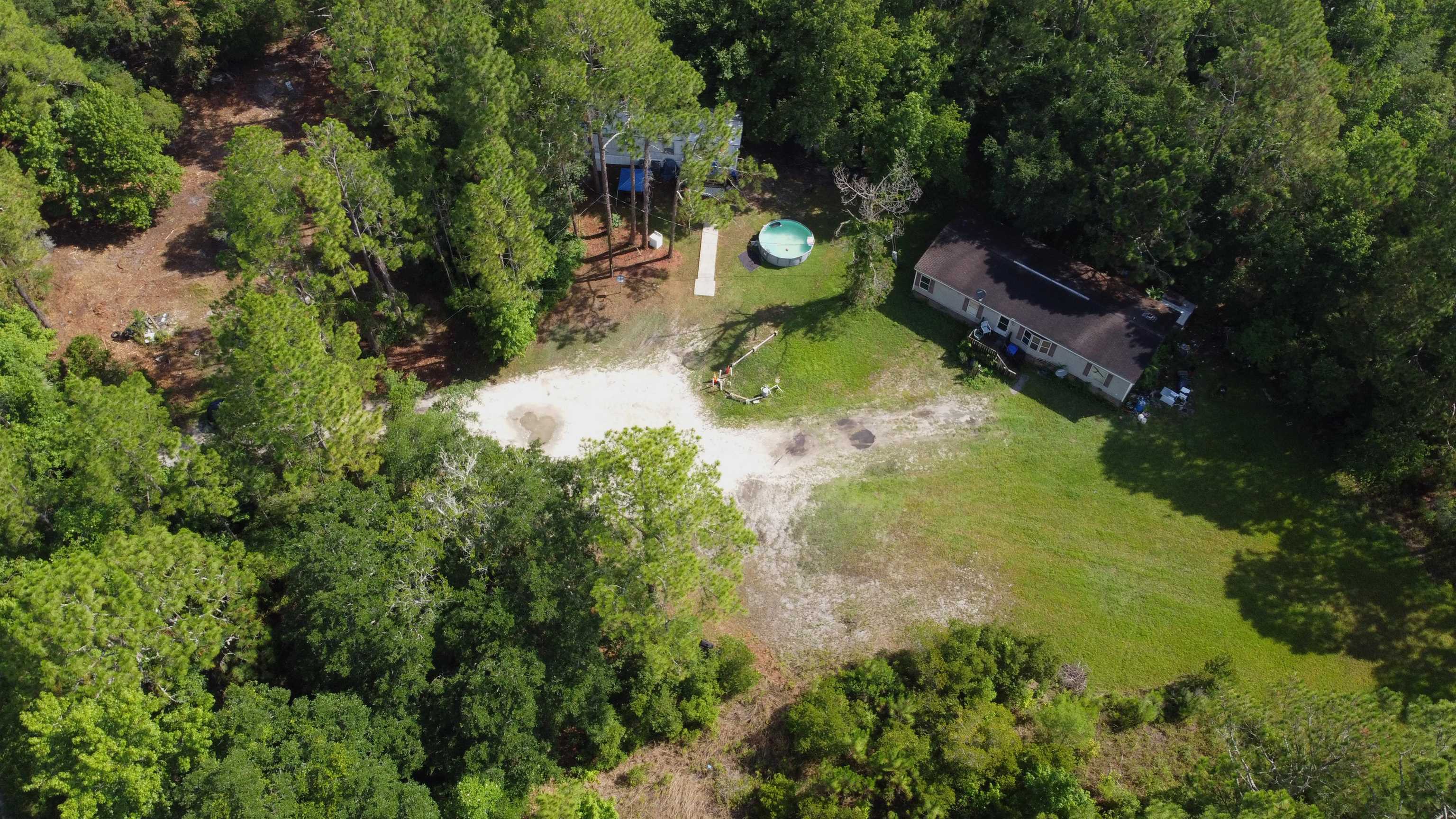 2100 Deer Run Road St. Augustine, FL 32084 - Photo 2 of 17 an aerial view of a house with swimming pool a yard and a fountain