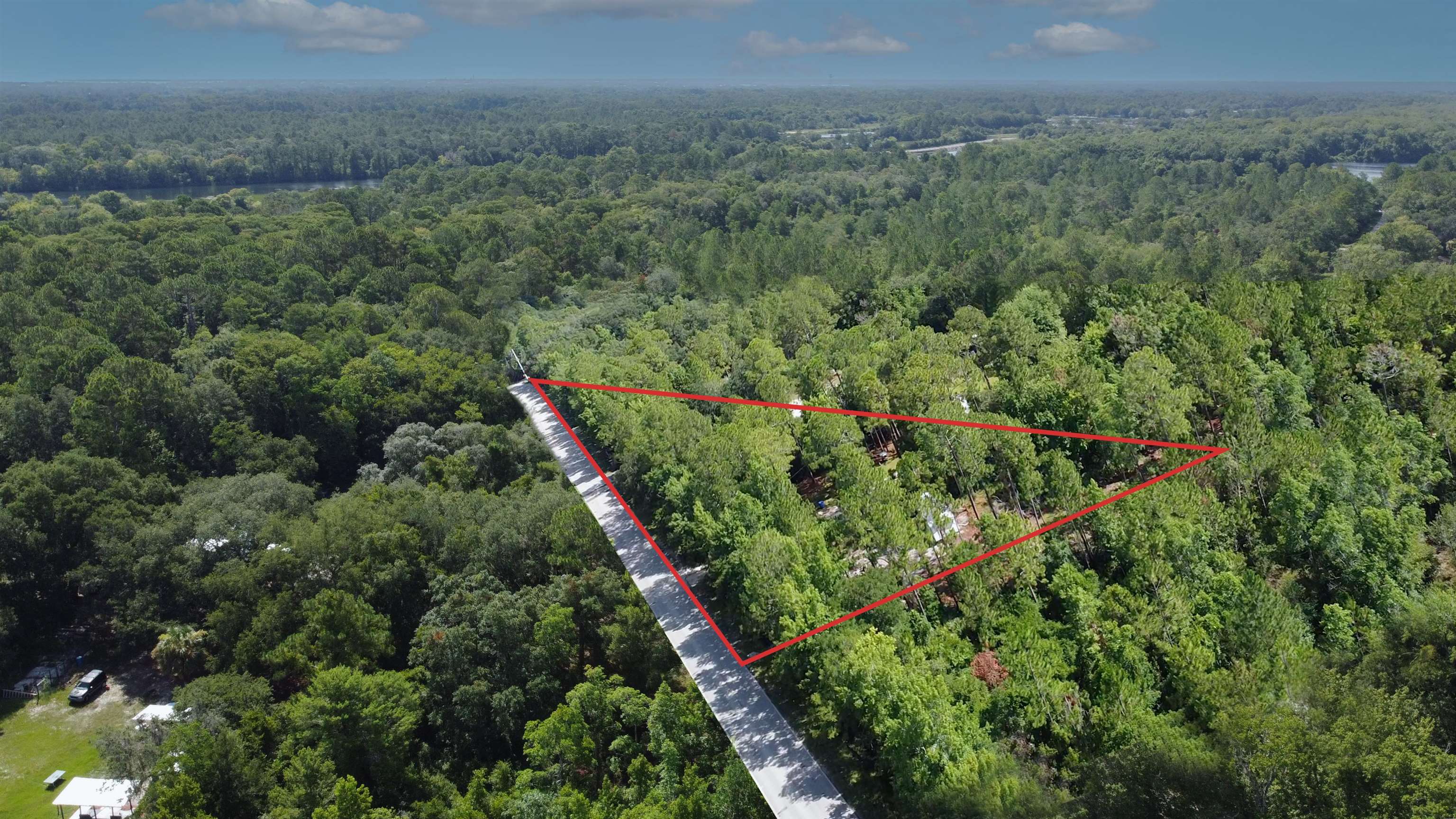 2100 Deer Run Road St. Augustine, FL 32084 - Photo 4 of 17 an aerial view of a house with a lush green forest