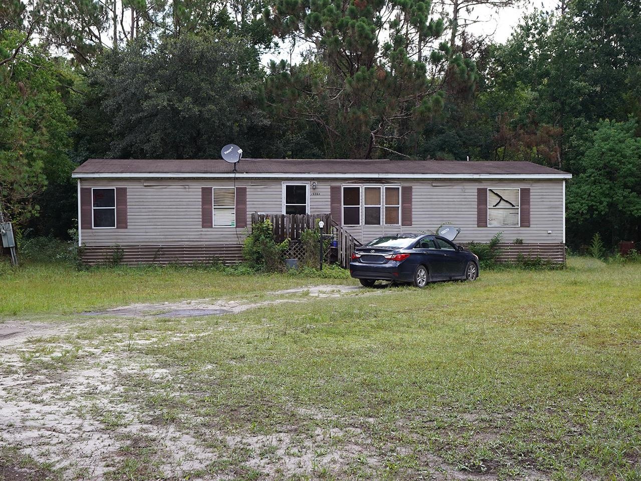 2100 Deer Run Road St. Augustine, FL 32084 - Photo 9 of 17 a house that has a lot of plants and trees in the background