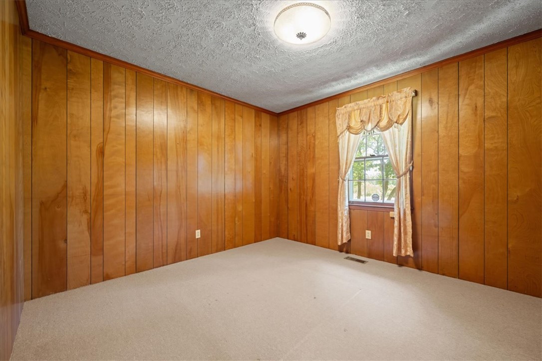 304 Shaw Road Honea Path, SC 29654 - Photo 17 of 39 This versatile room, ready for your personal touch, offers a cozy retreat with warm wood paneling.