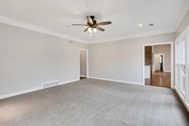 a view of a livingroom with a ceiling fan and window