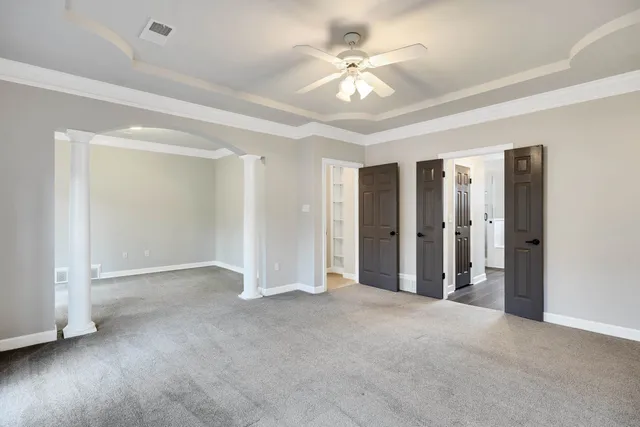 a view of an empty room with a ceiling fan
