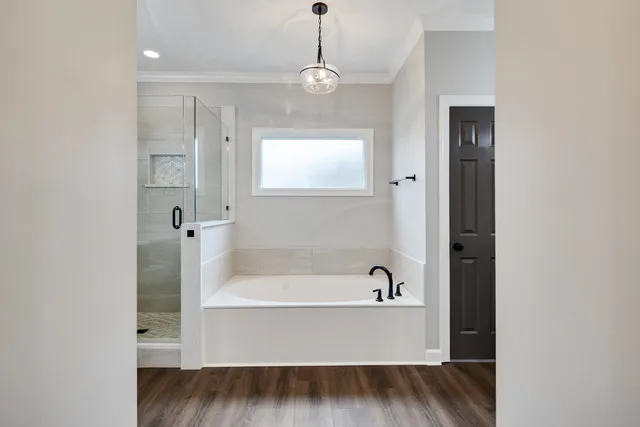 a bathroom with a bathtub and a window