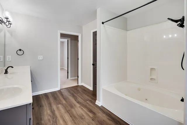 a bathroom with a bathtub and a sink