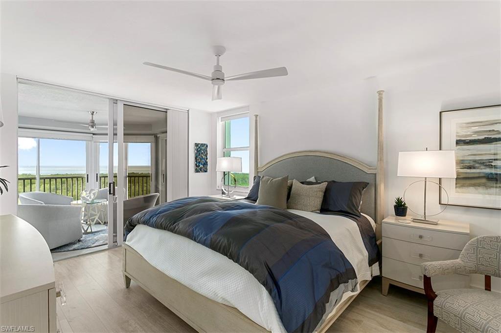 6573 Marissa Loop, Unit 903 Naples, FL 34108 - Photo 11 of 25 a bedroom with a balcony a bed and a couch