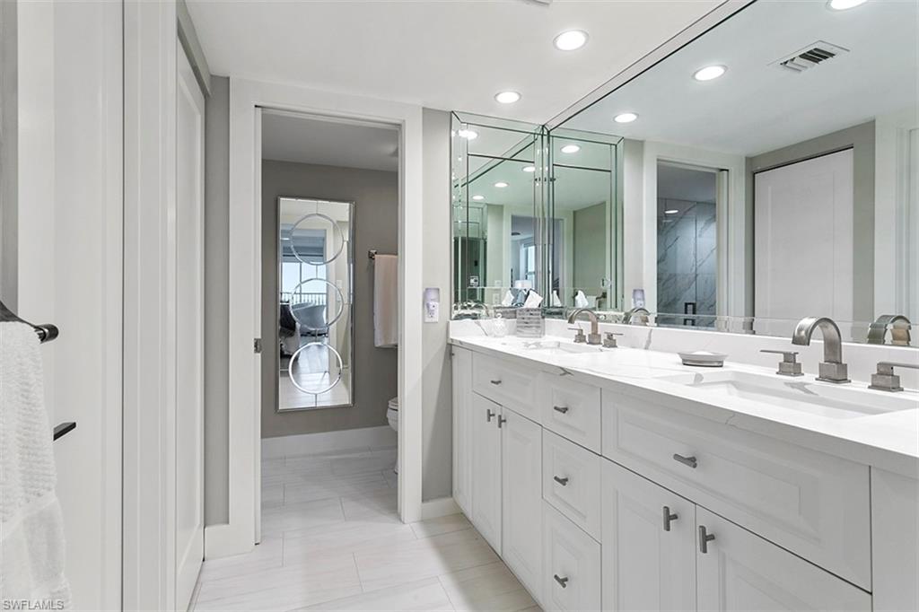 6573 Marissa Loop, Unit 903 Naples, FL 34108 - Photo 12 of 25 a bathroom with a double vanity sink mirror and next to a window