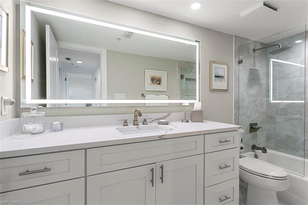 6573 Marissa Loop, Unit 903 Naples, FL 34108 - Photo 15 of 25 a bathroom with a granite countertop sink mirror and toilet