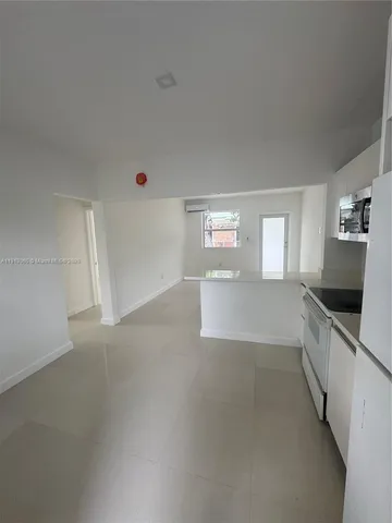 a view of a kitchen and window in a room
