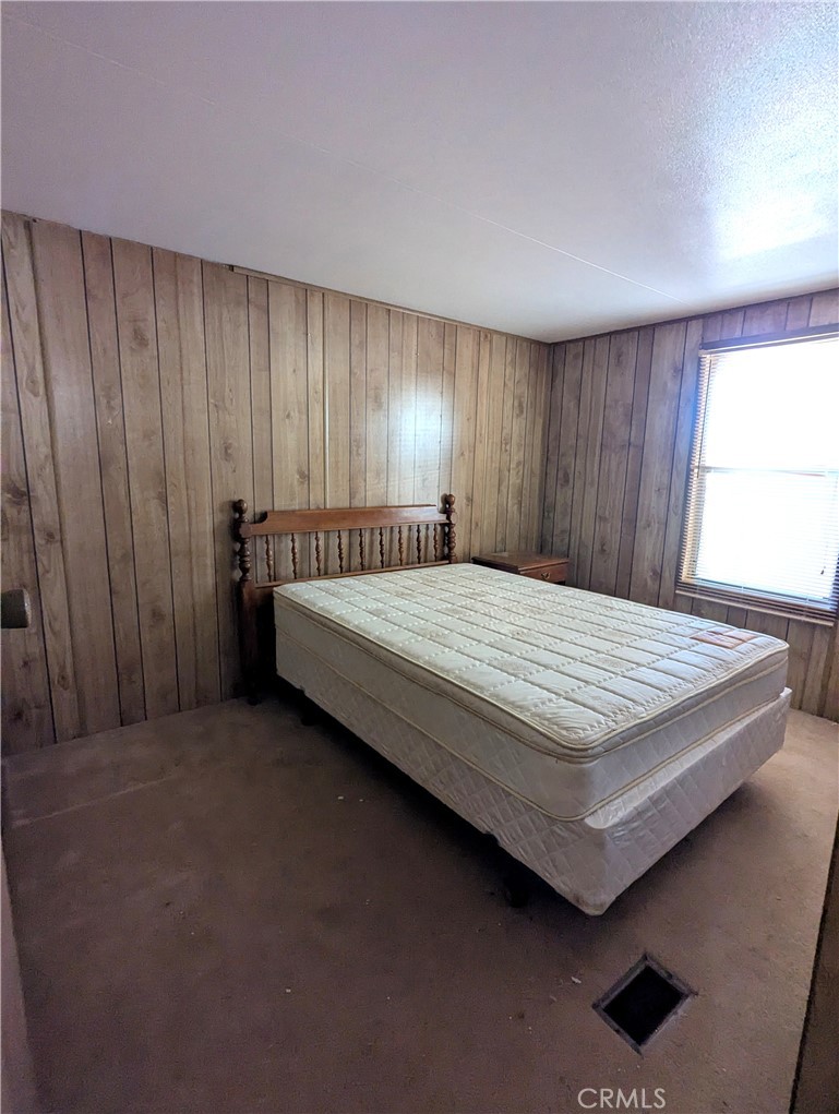 10200 Johnson Road, Unit 36 Phelan, CA 92371 - Photo 14 of 22 a bedroom with a bed and window
