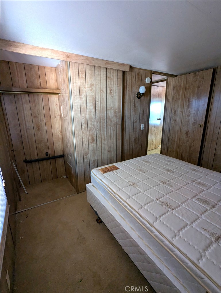 10200 Johnson Road, Unit 36 Phelan, CA 92371 - Photo 15 of 22 a bedroom with a bed and a window